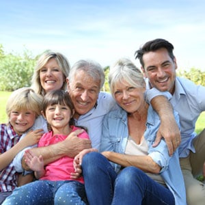 A happy family sitting on the grass - The Emory Law Firm